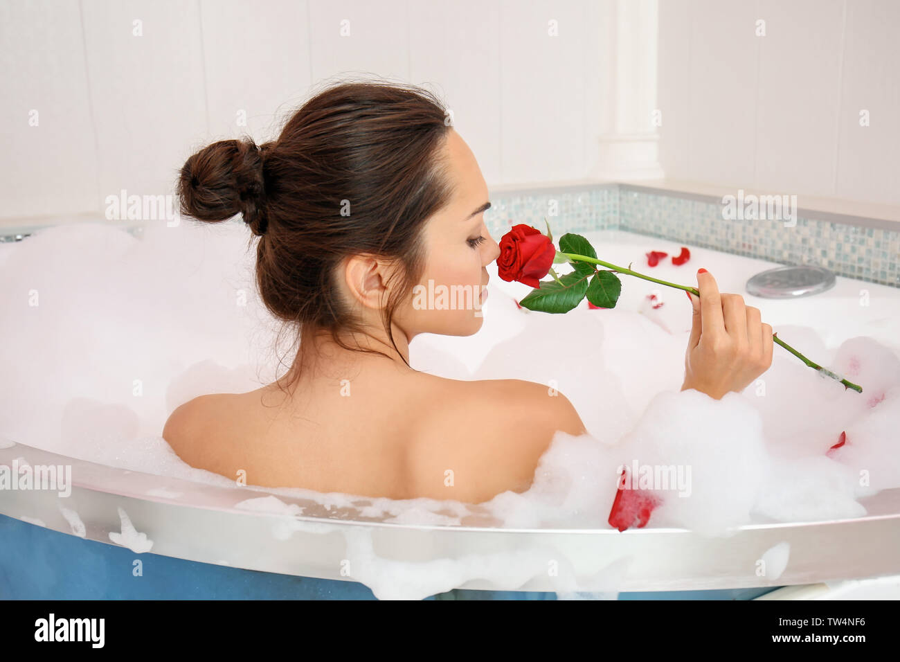 Beautiful woman with rose in bathtub Stock Photo Alamy