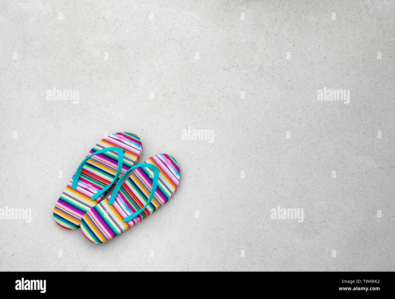Flip-flops on beach sand. Summer vacation concept Stock Photo - Alamy