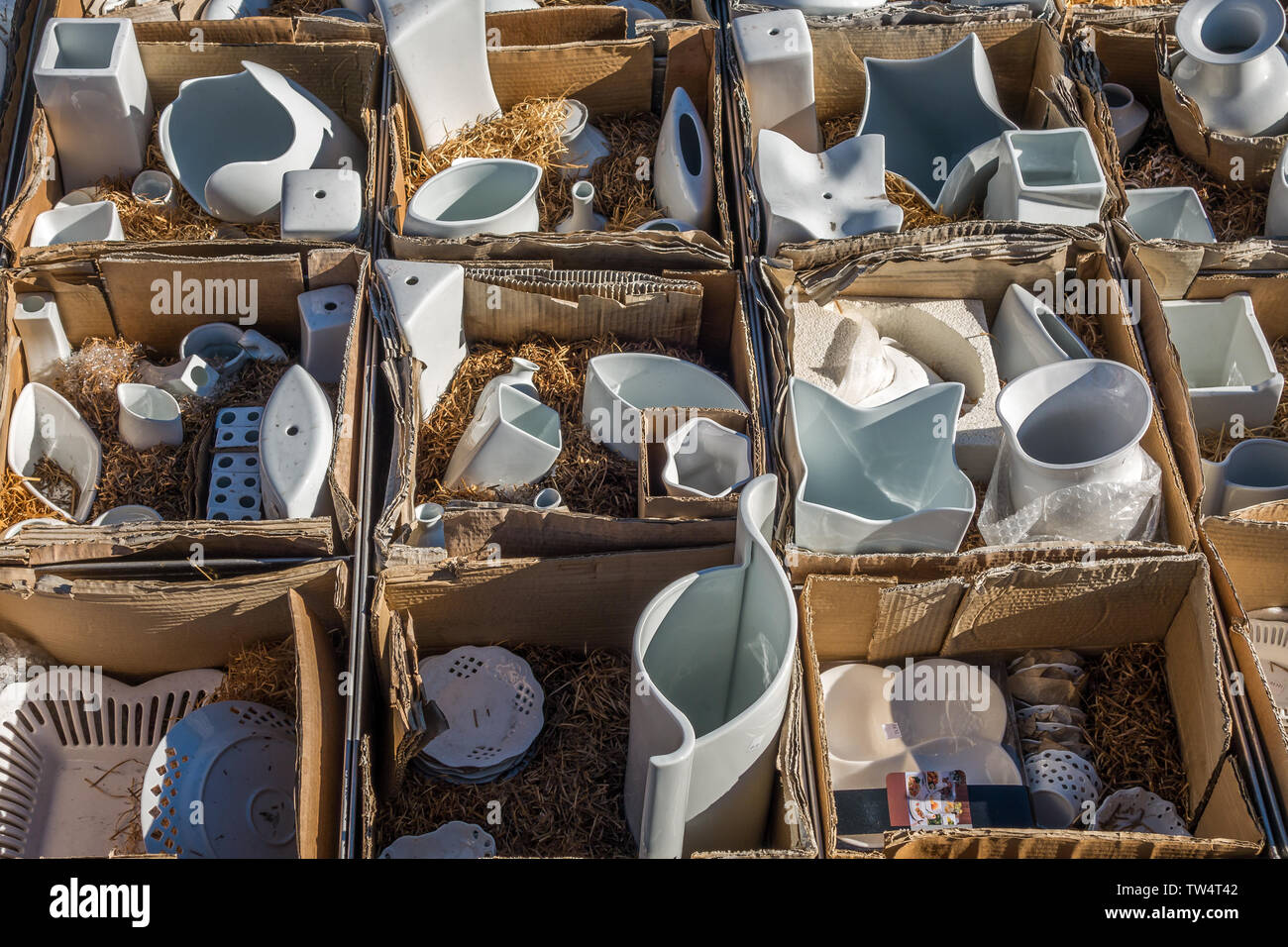Chamonix, France - 23 March 2019: Closeup of various white porcelain items on display in trays crates and boxes at Saturday market place in Chamonix F Stock Photo