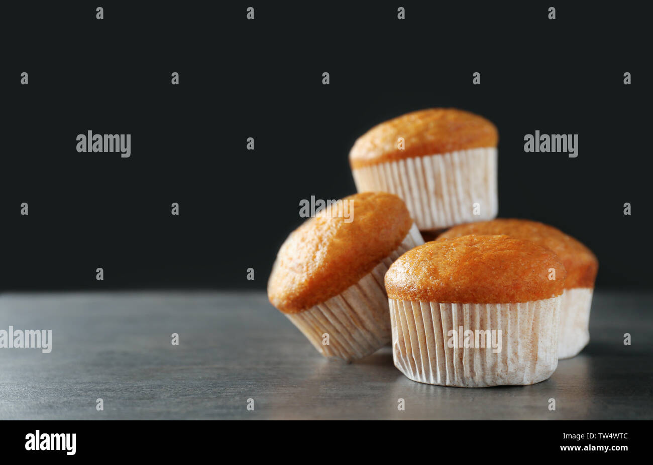 Delicious carrot muffins on dark background Stock Photo