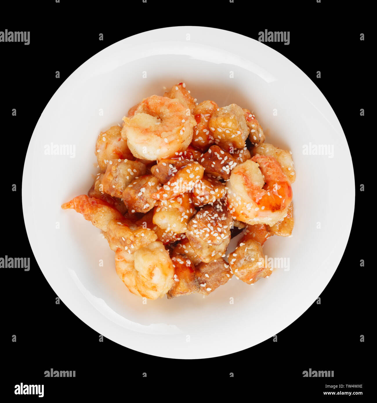 Deep fried eggplant and shrimps in sweet-sour sauce, isolated on black Stock Photo