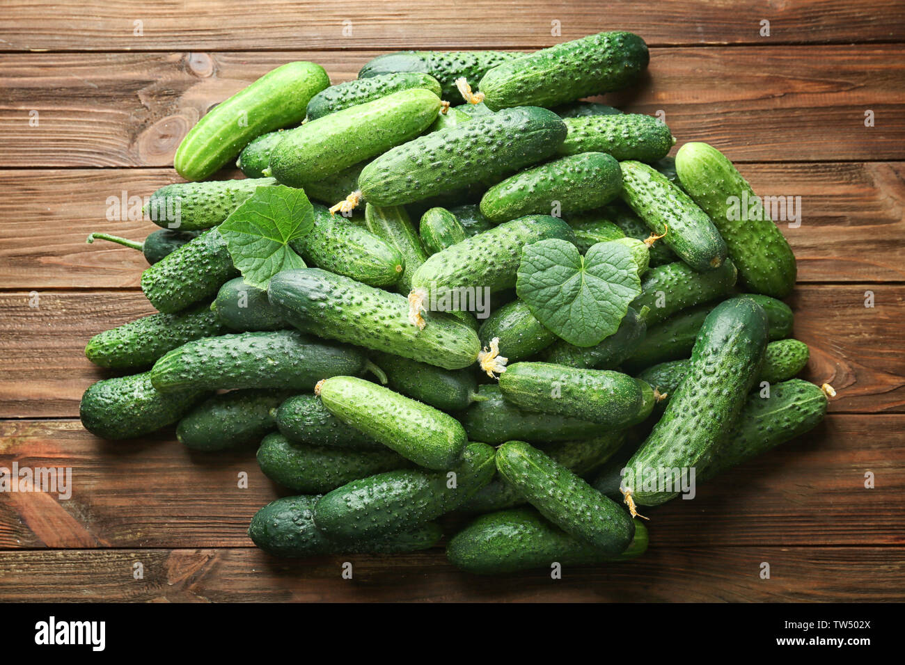 Many green fresh cucumbers on wooden background Stock Photo Alamy Many green fresh cucumbers on wooden background Stock Photo Alamy