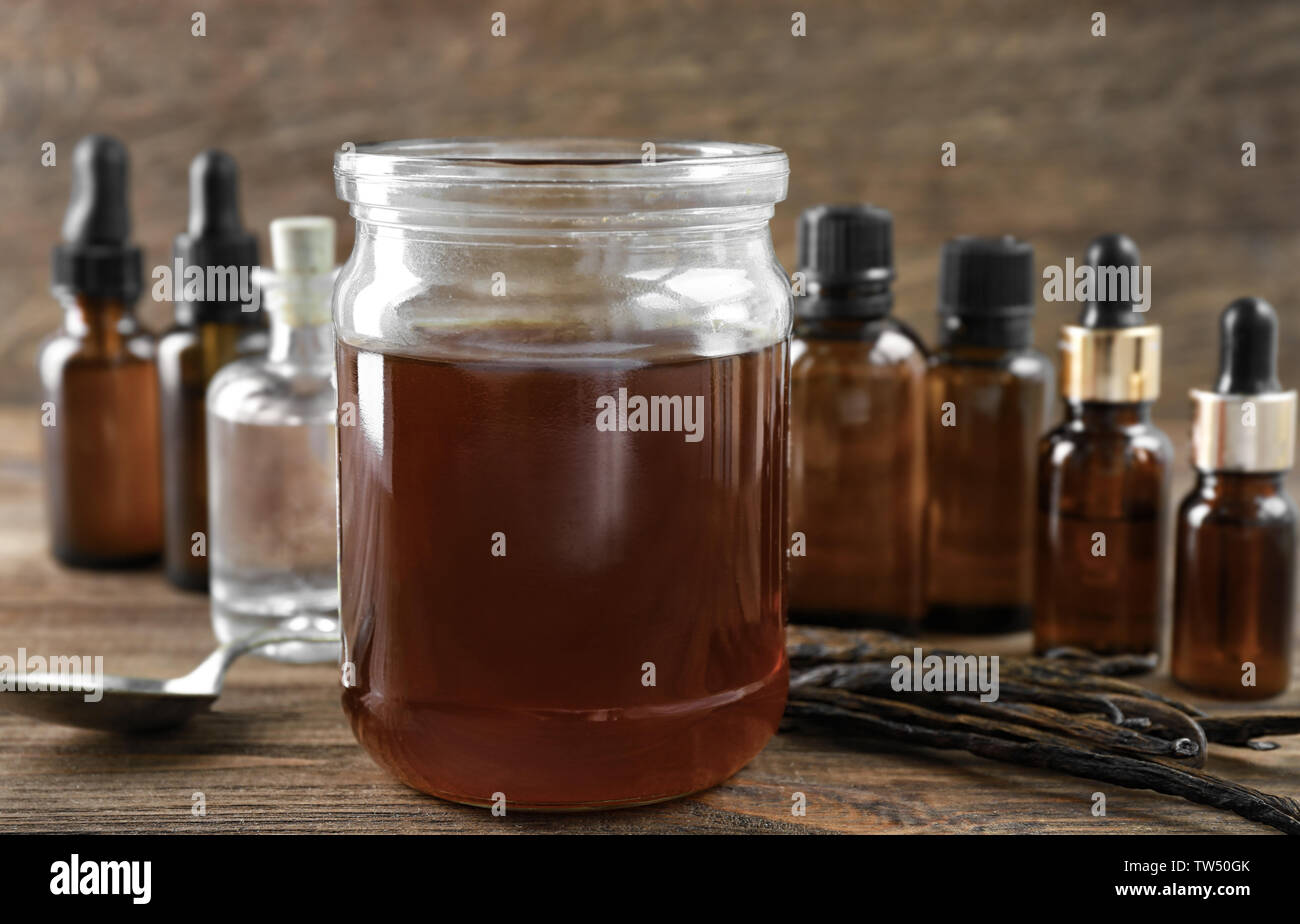 Jar with aromatic vanilla extract on table Stock Photo Alamy