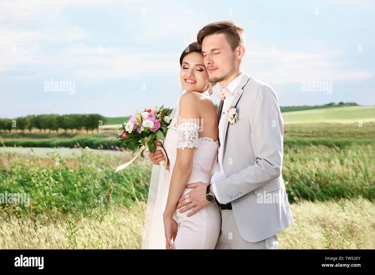 Happy beautiful couple on wedding day, outdoors Stock Photo - Alamy