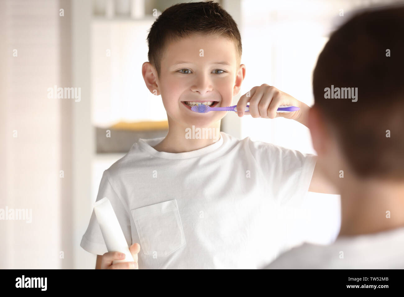 Cute little boy cleaning teeth at home Stock Photo Alamy