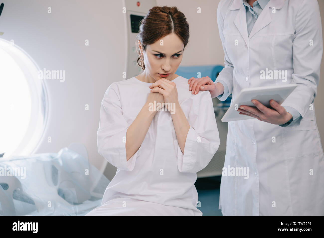 partial view of radiologist showing digital tablet with x-ray diagnosis ...