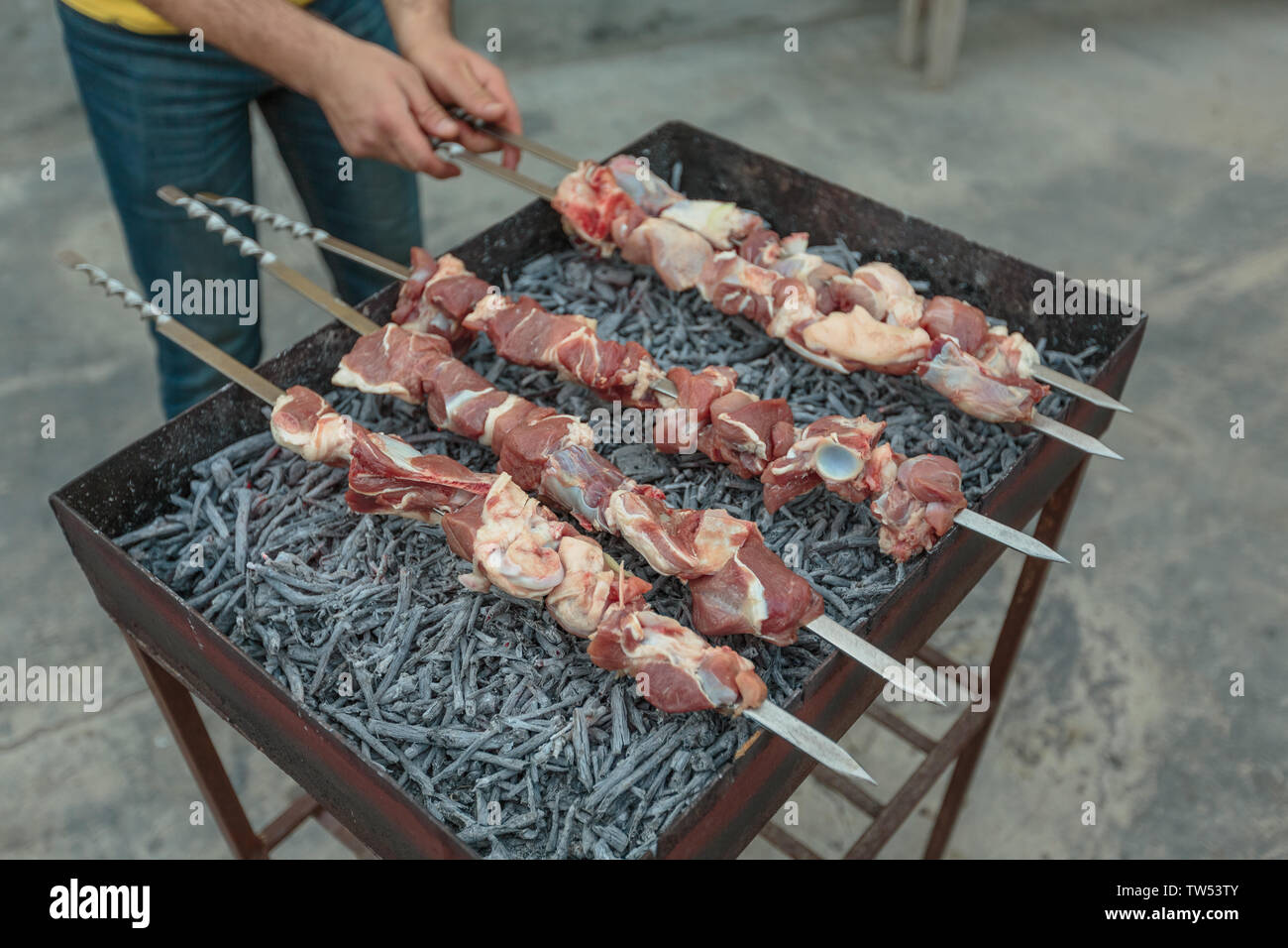 meat strung on skewers on the grill Stock Photo