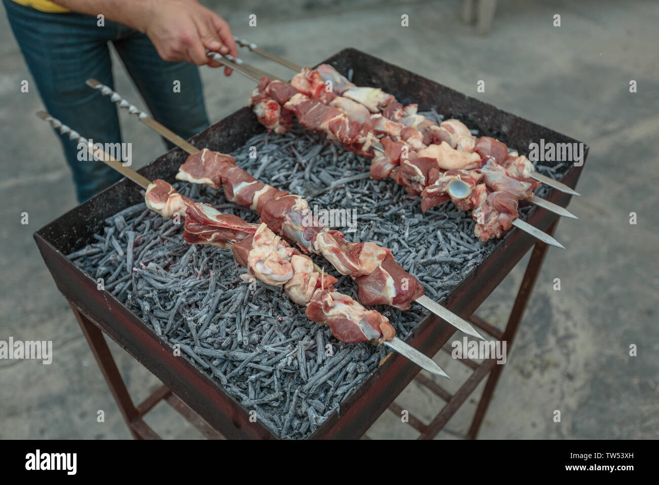 meat strung on skewers on the grill Stock Photo