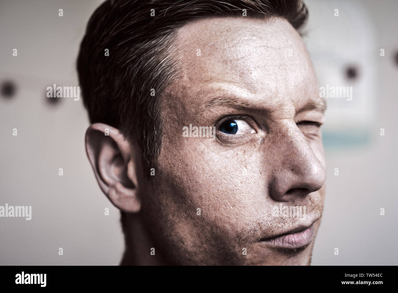 Serious but inquisitive looking man looking directly at camera Stock Photo