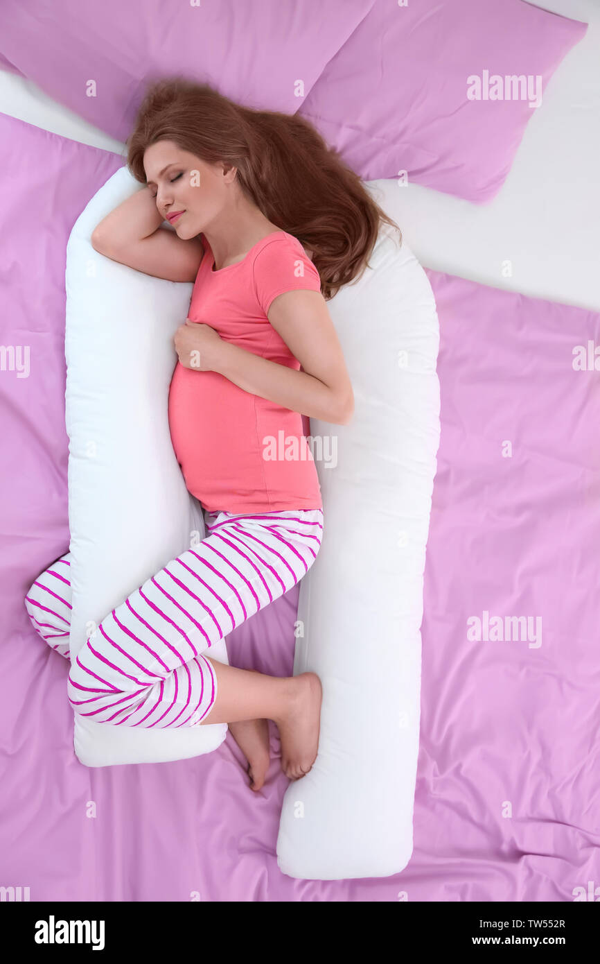 Beautiful Pregnant Woman Sleeping With Body Pillow Stock Photo