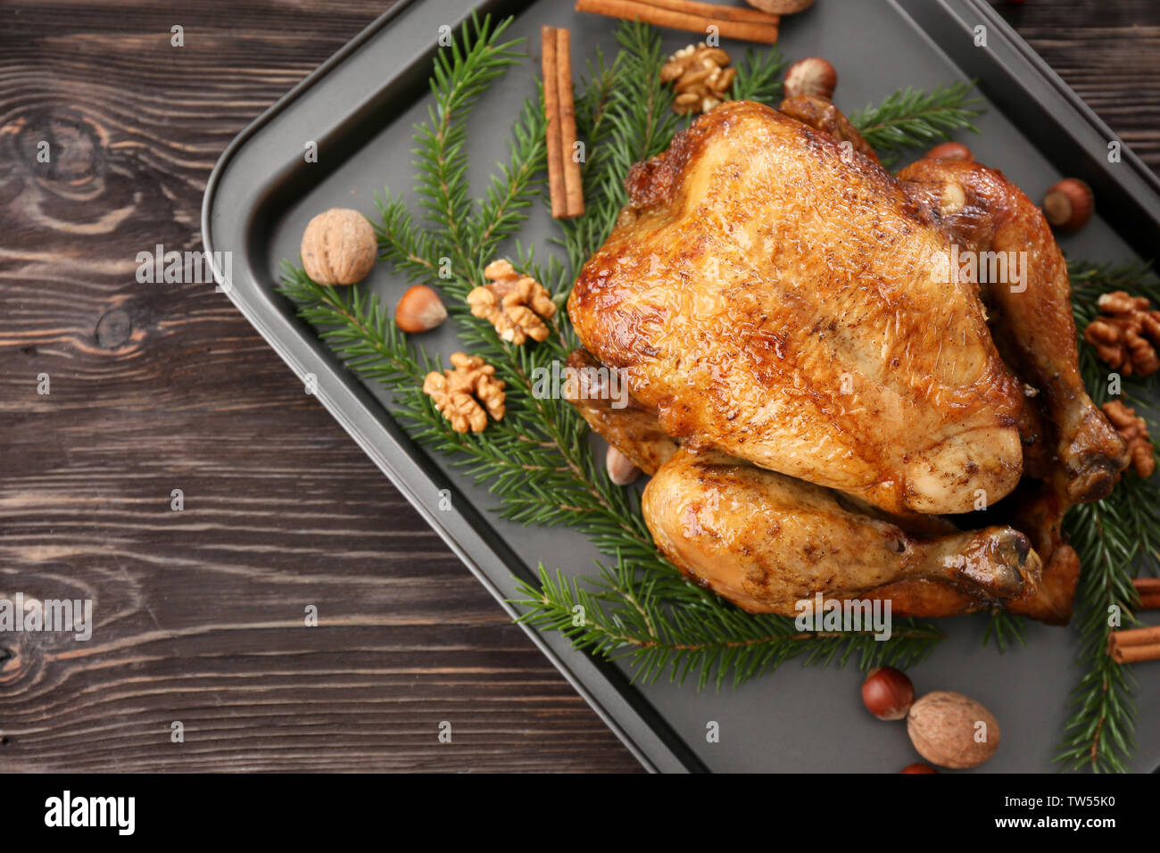 Roasted turkey with fir tree branches and nuts on baking sheet Stock ...