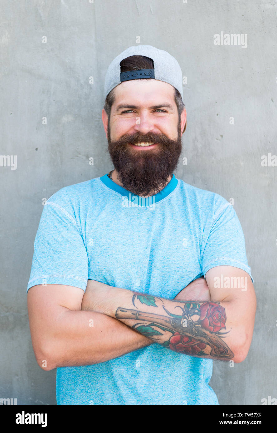 Guy modern outfit. Casual and comfortable. Hipster lifestyle. Cool hipster  with beard wear stylish baseball cap. Brutal handsome hipster man resting  on summer day. Bearded man trendy hipster style Stock Photo -