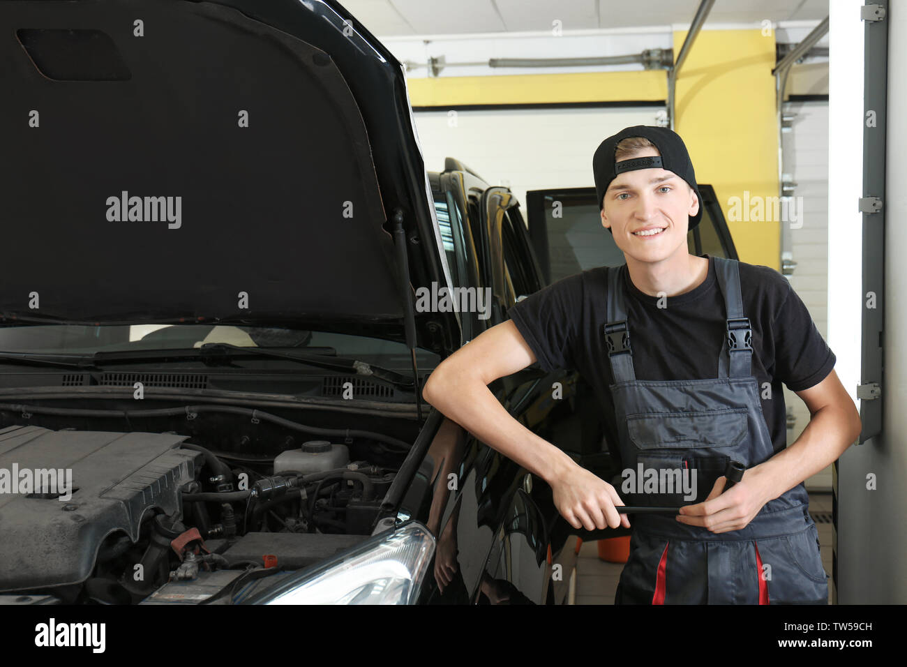 Young mechanic in body shop Stock Photo