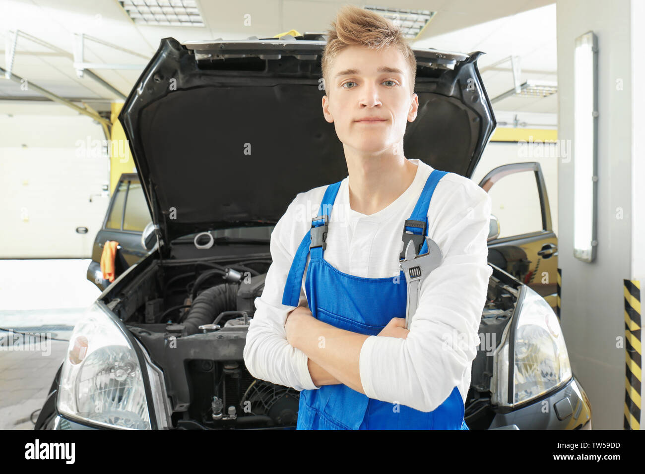 Young mechanic in body shop Stock Photo