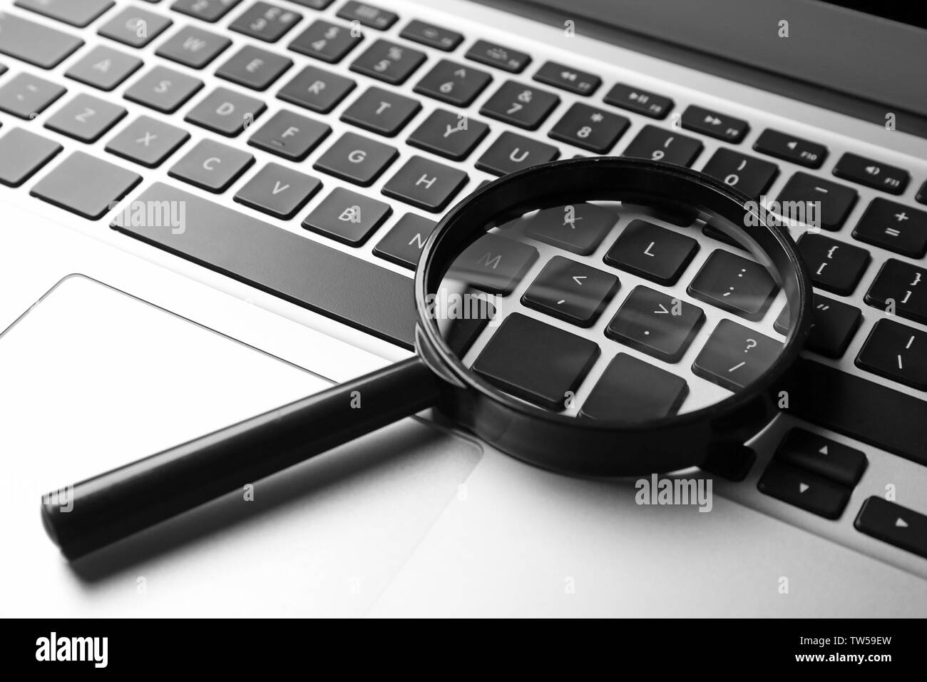 Magnifying glass on laptop. search concept Stock Photo Alamy