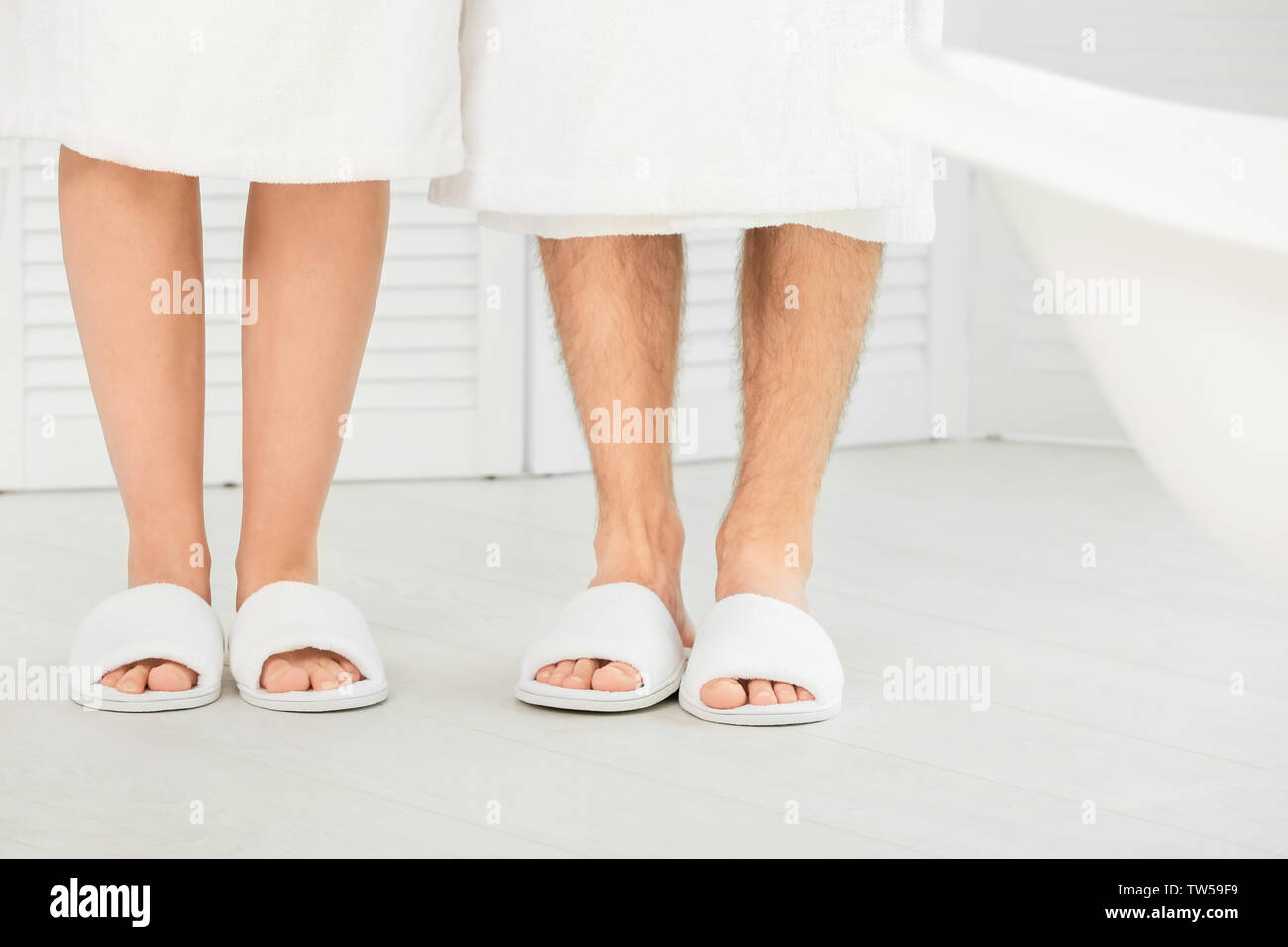 Couple in bathing slippers at home Stock Photo - Alamy