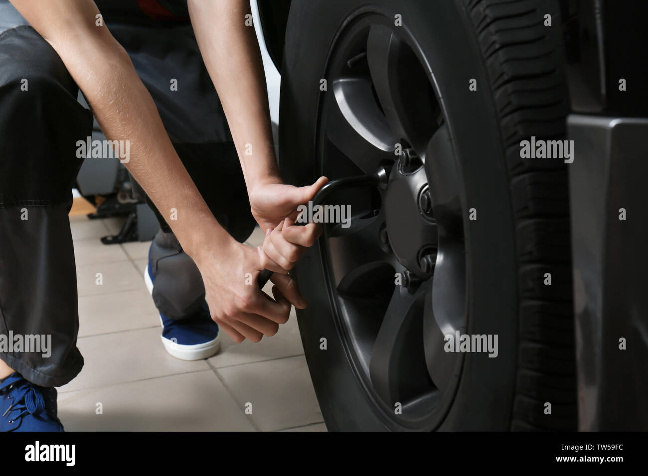 Young mechanic working in body shop Stock Photo