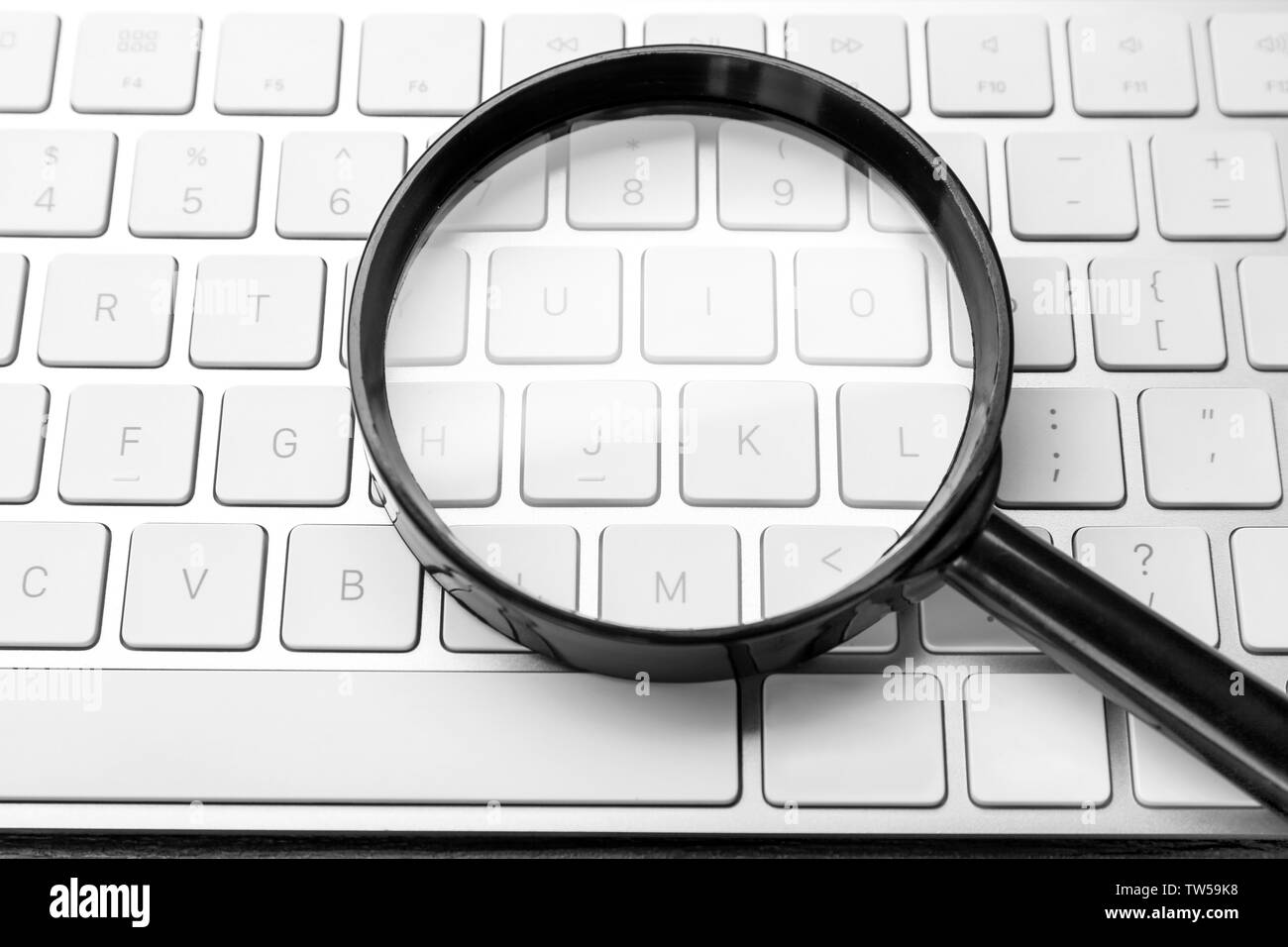 Magnifying glass on keyboard. search concept Stock Photo Alamy