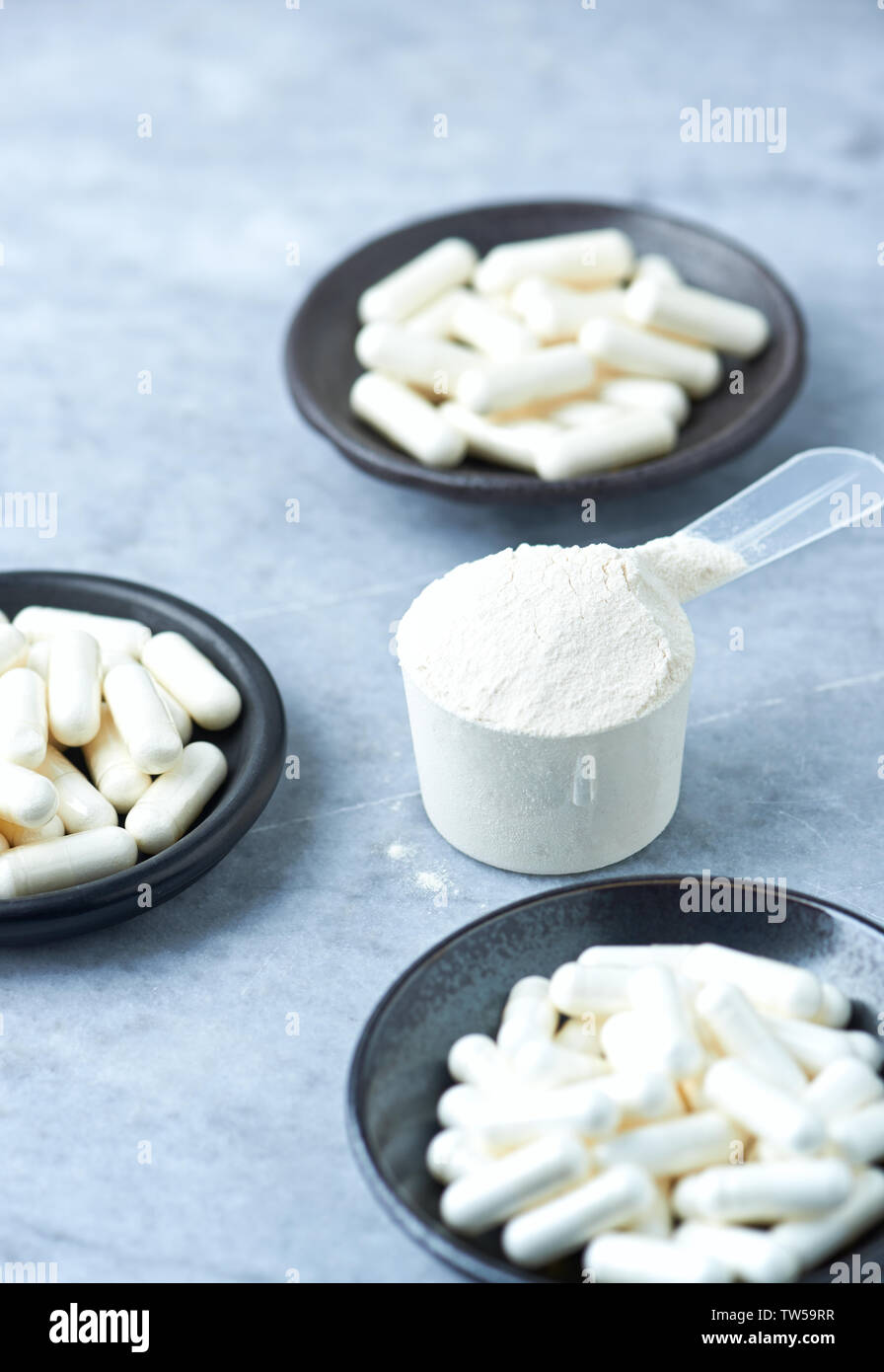 Creatine, Betaalanine, Taurine capsules and a Scoop of Whey Protein