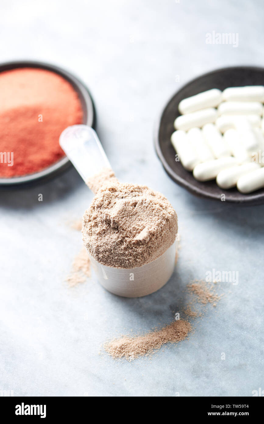 Scoop of Whey Protein, Betaalanine capsules and Creatine Powder Stock