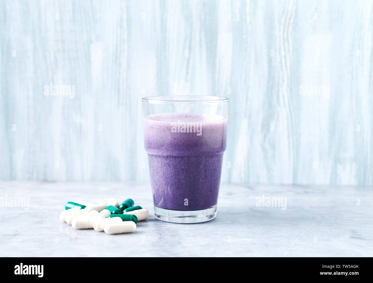 l carnitine and protein shake Glass of with milk blueberries, Beta-alanine and L- capsules in background Stock Photo كريم مهدئ للهالات والانتفاخ Galactomyces Glutathione Glow Milky Flavour:Pineapple Kiwi free and offered in