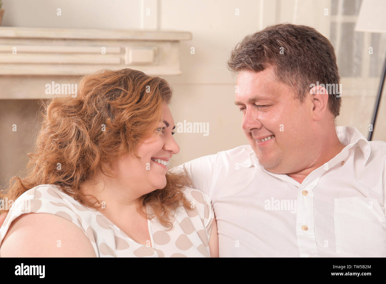 Overweight couple at home Stock Photo