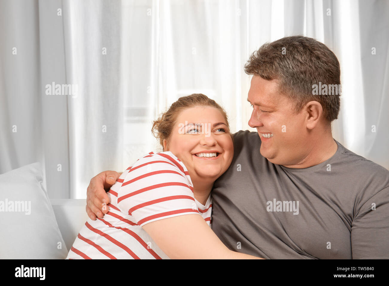 Overweight couple at home Stock Photo