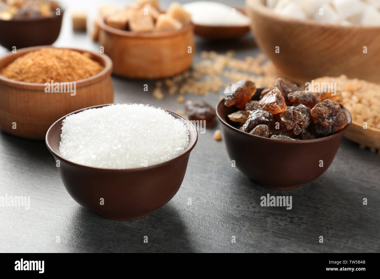 Various kinds of sugar on grey table stock photo alamy