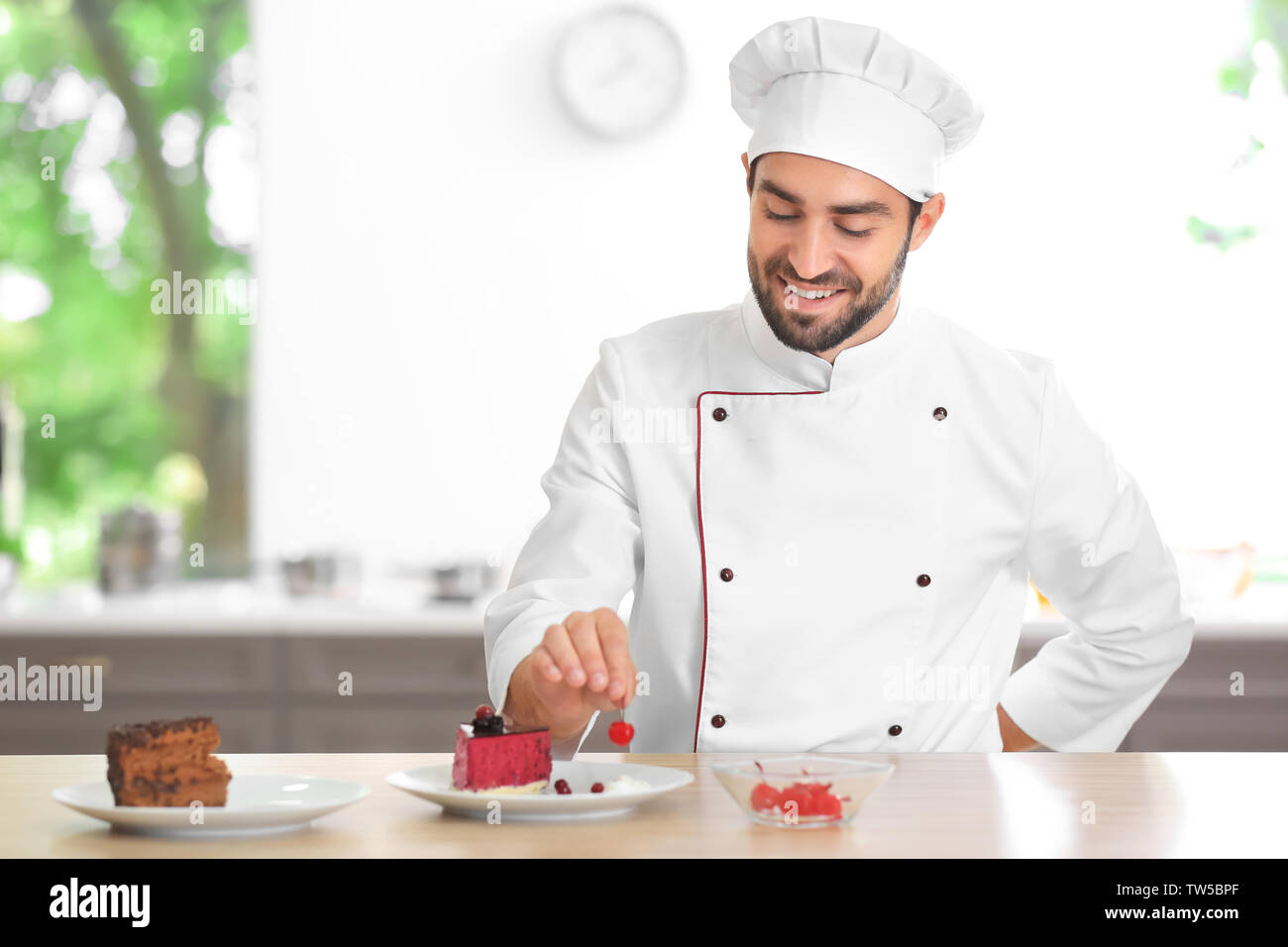 Young Male Chef Decorating Cake In Kitchen Stock Photo 256430567