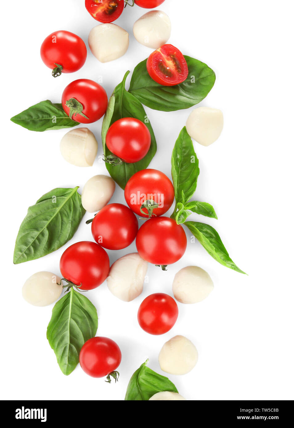 Mozzarella cheese balls, cherry tomatoes and green fresh organic basil isolated on white Stock