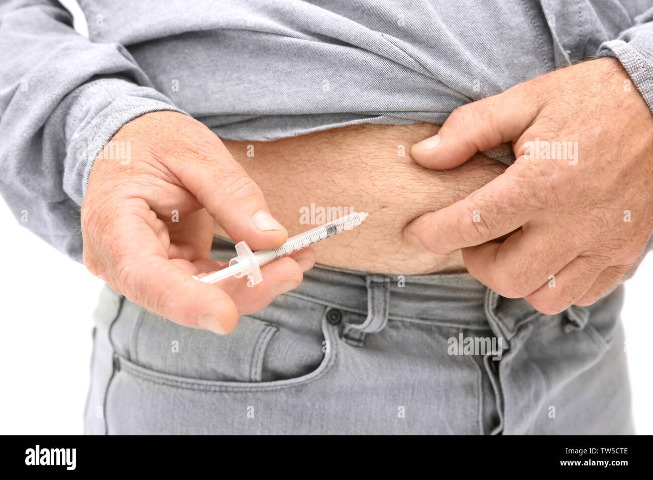 Diabetic patient injecting insulin in stomach, closeup Stock Photo
