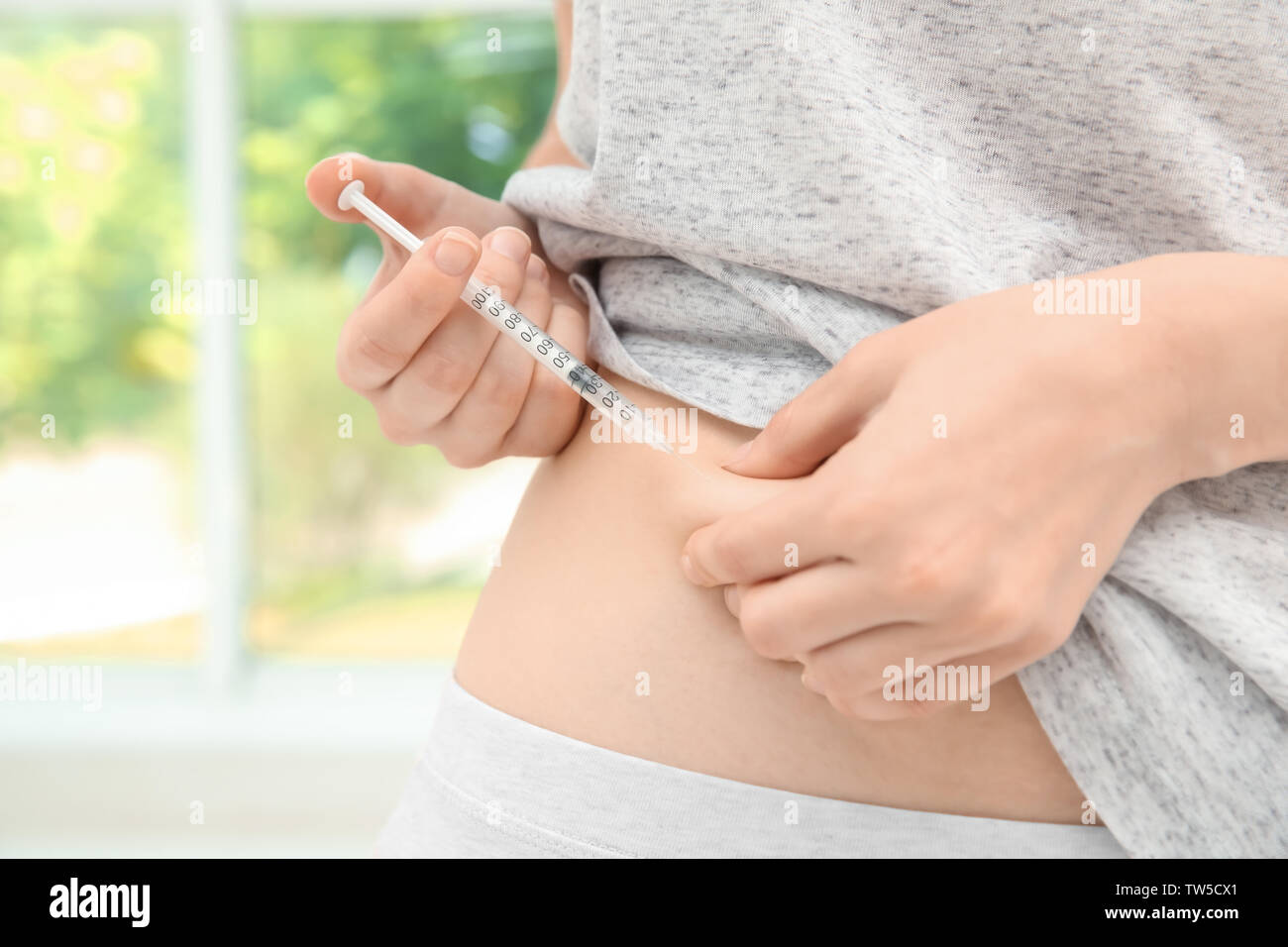 Diabetic patient injecting insulin in stomach, closeup Stock Photo - Alamy