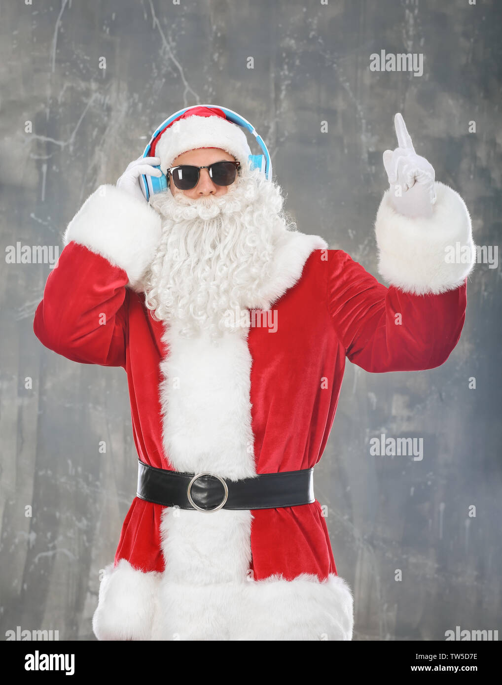 Santa Claus listening to music on grunge background Stock Photo - Alamy