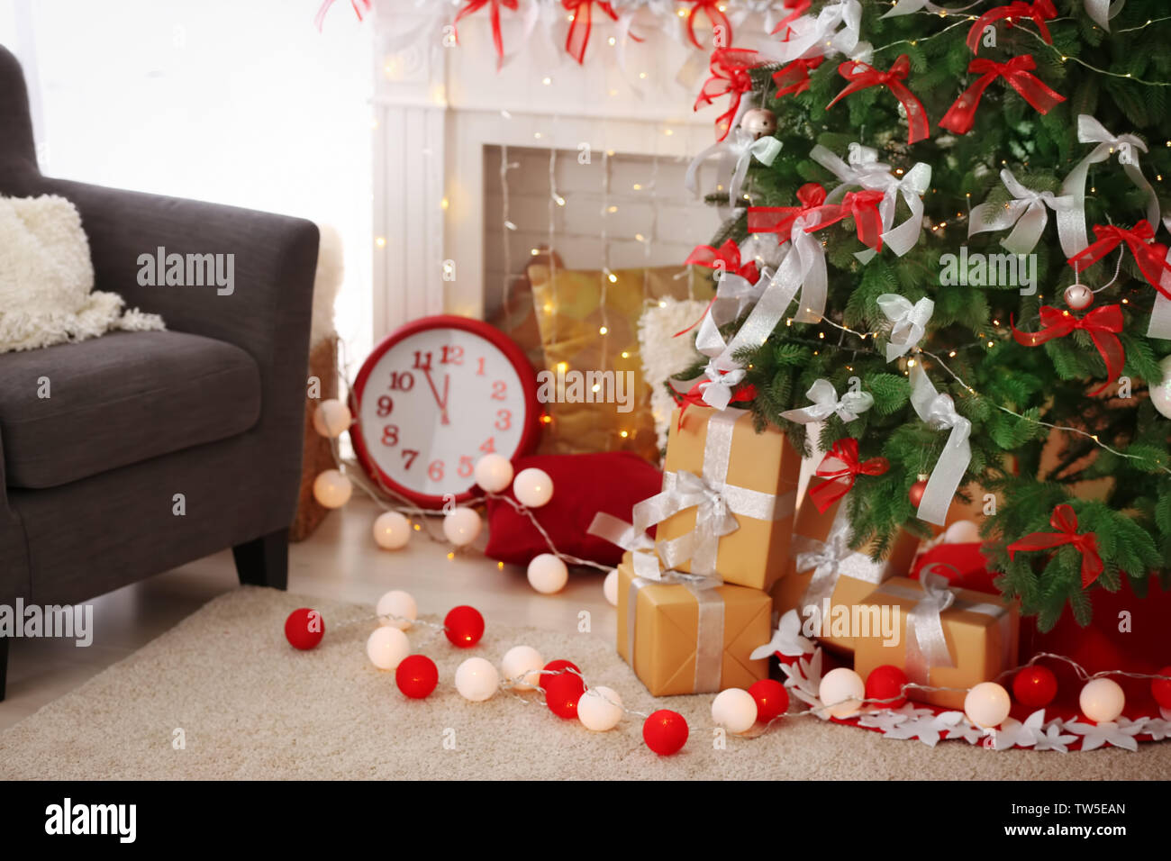 Gift boxes under beautiful fir tree decorated for Christmas in living ...
