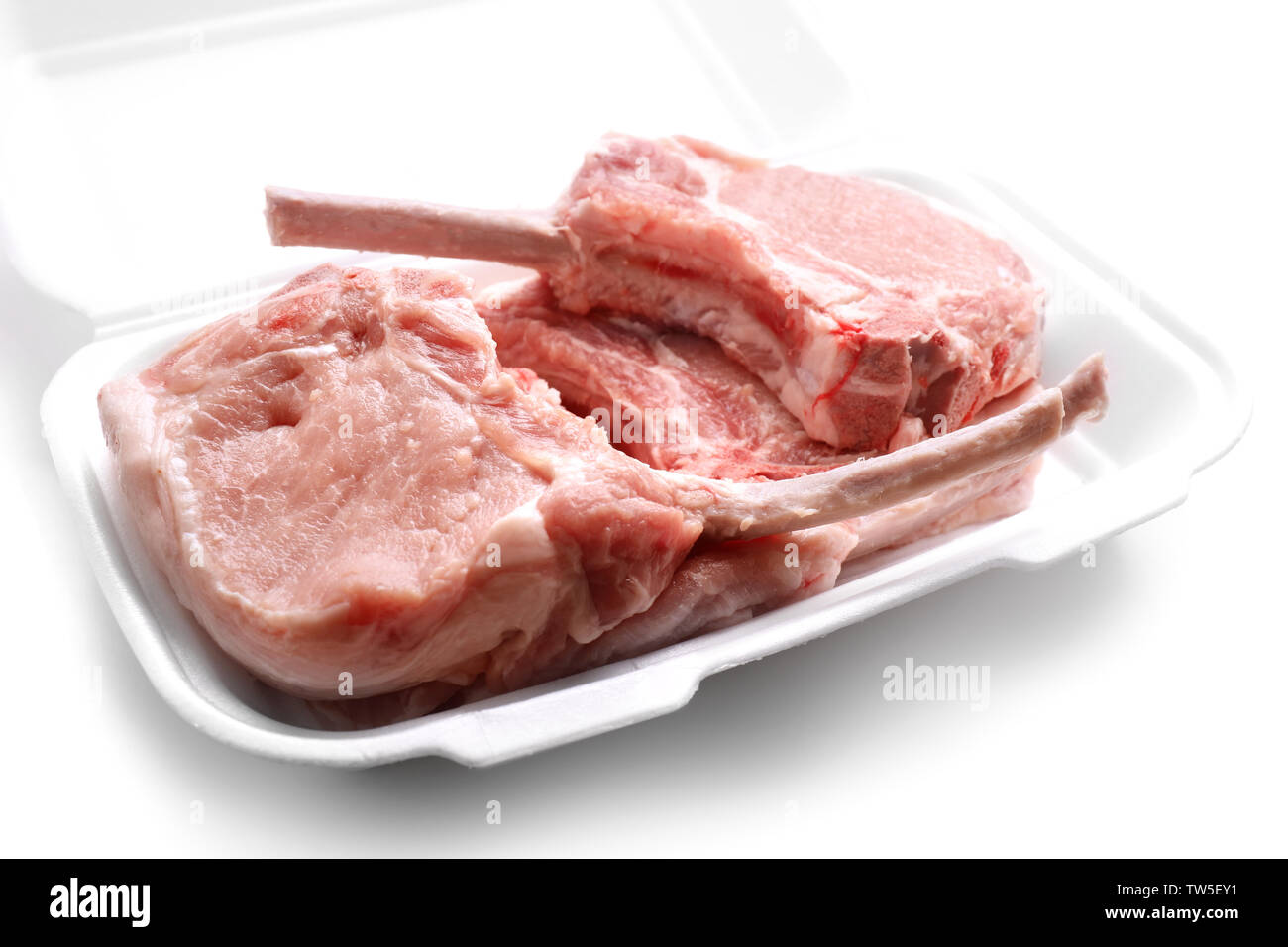 Raw ribs in container on white background Stock Photo - Alamy