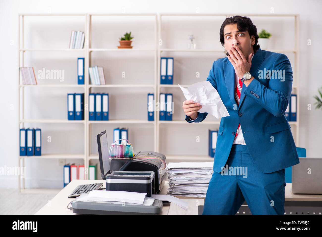 Young employee making copies at copying machine Stock Photo - Alamy