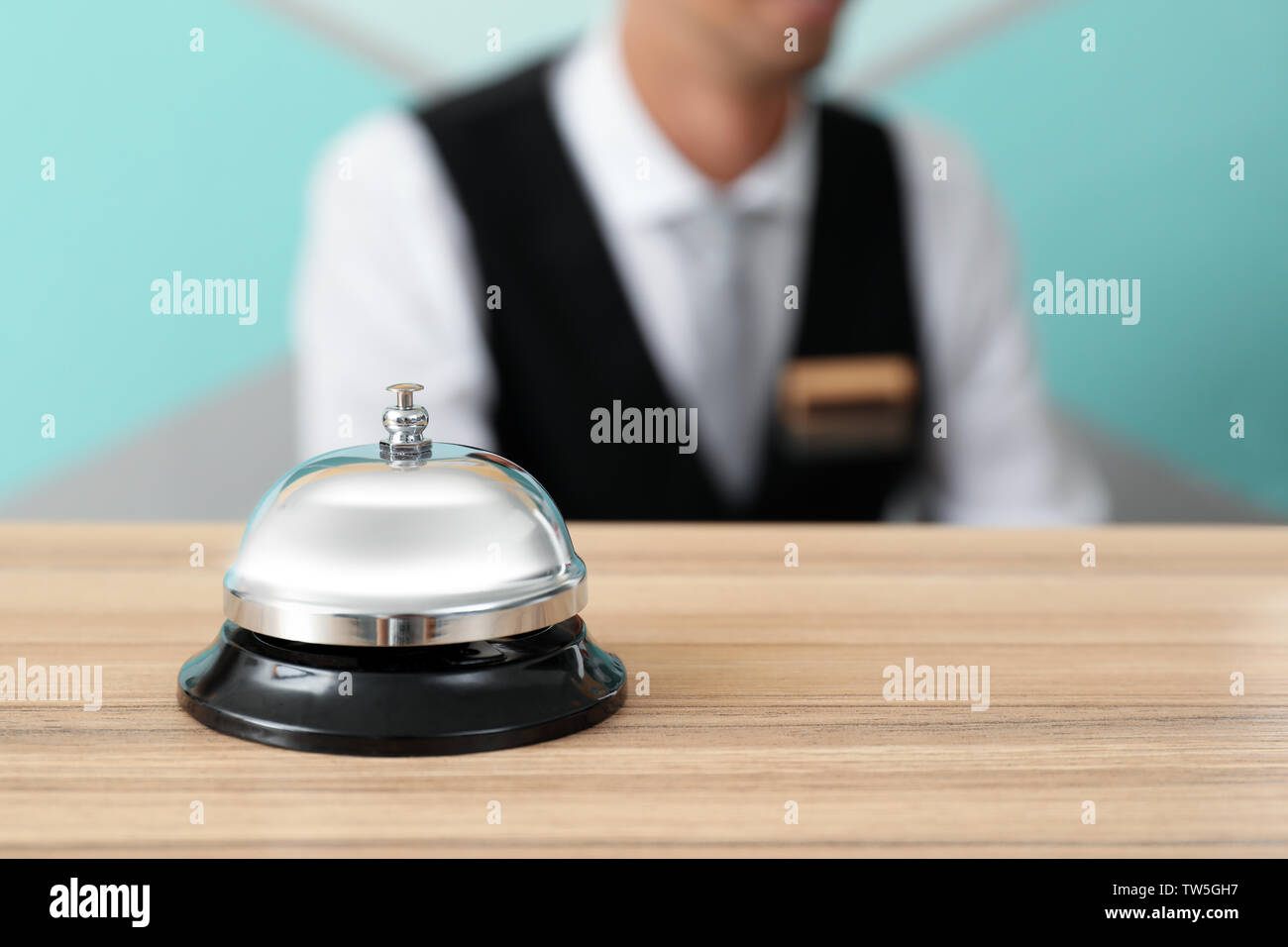 Silver Service Bell On Reception Desk In Hotel Stock Photo