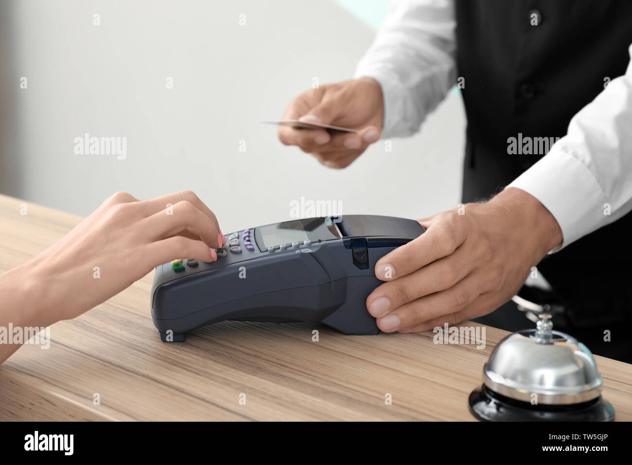 Client paying for hotel room at reception Stock Photo Alamy
