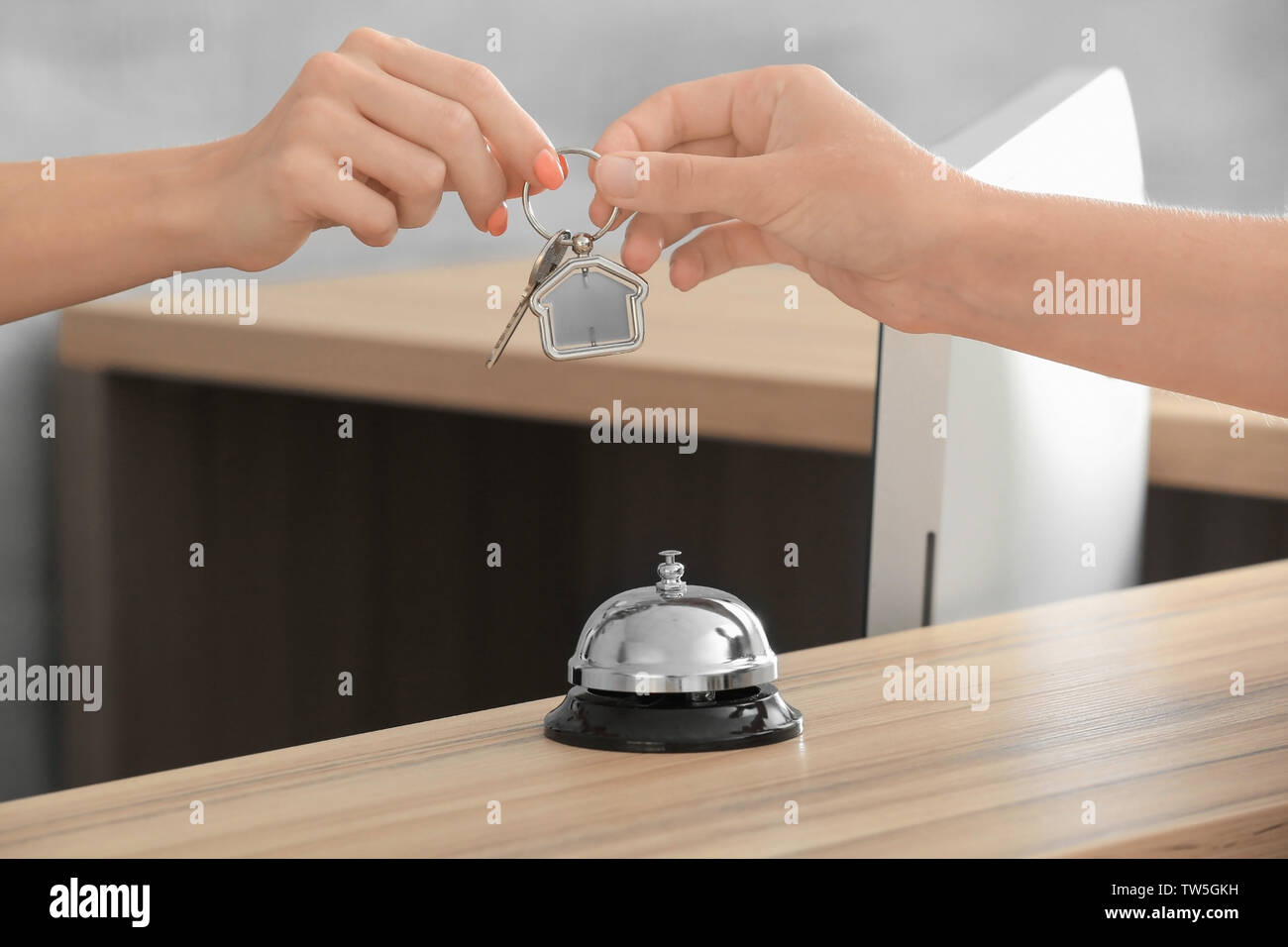 Female receptionist giving key from apartment to client Stock Photo Alamy
