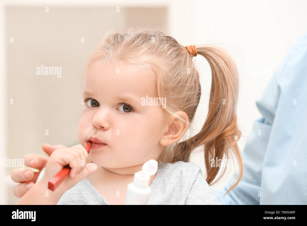 Little girl brushing teeth in bathroom Stock Photo