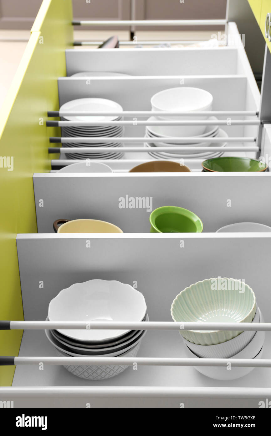 Set of tableware in kitchen drawers Stock Photo - Alamy