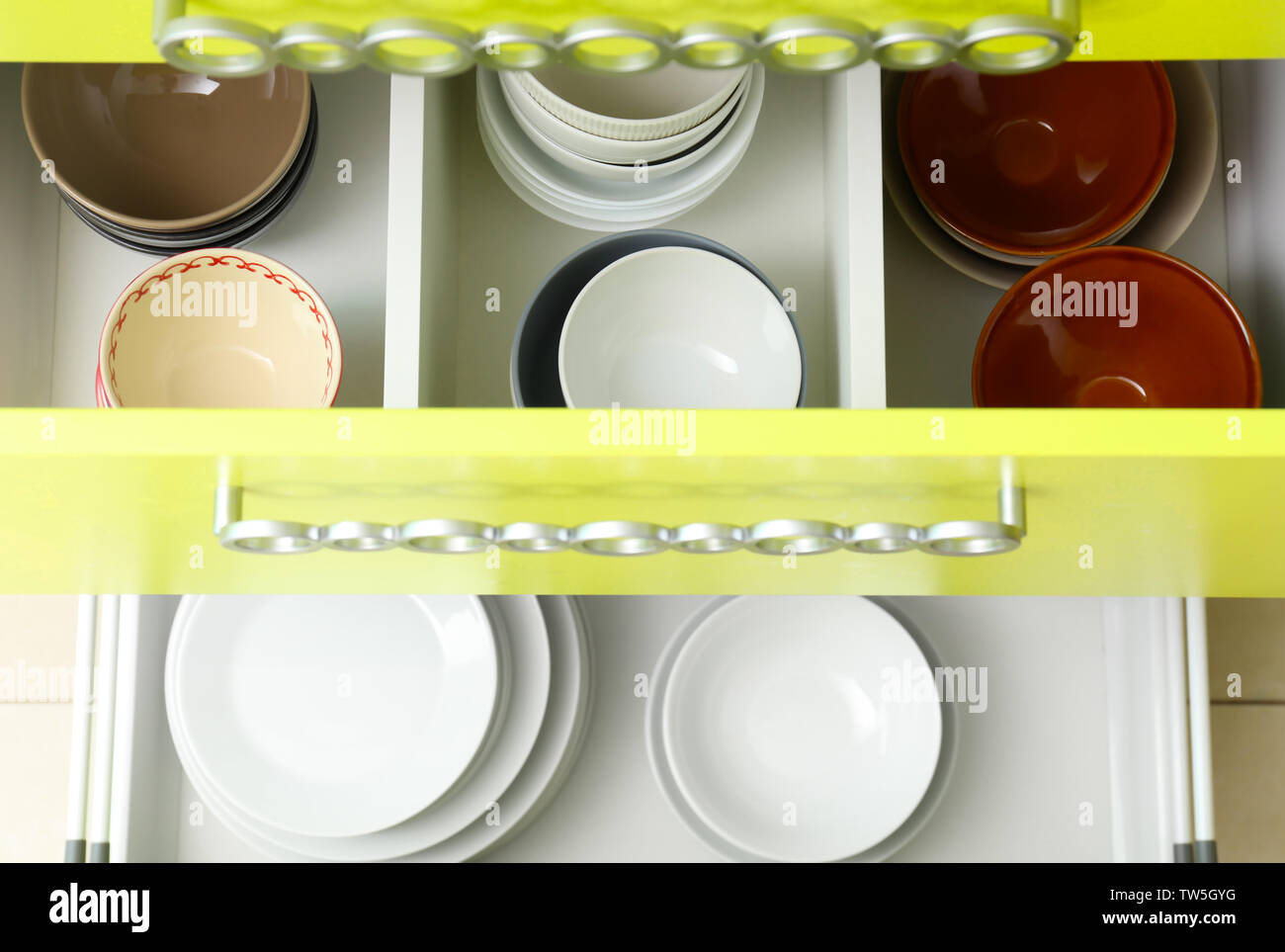 Set of tableware in kitchen drawers Stock Photo - Alamy