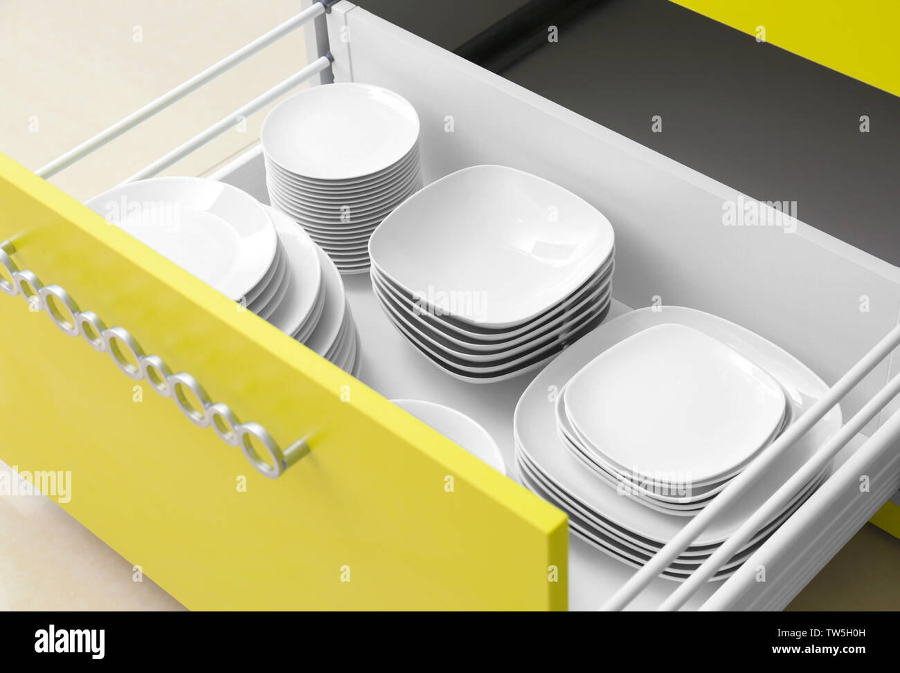 Plates in kitchen drawer Stock Photo Alamy