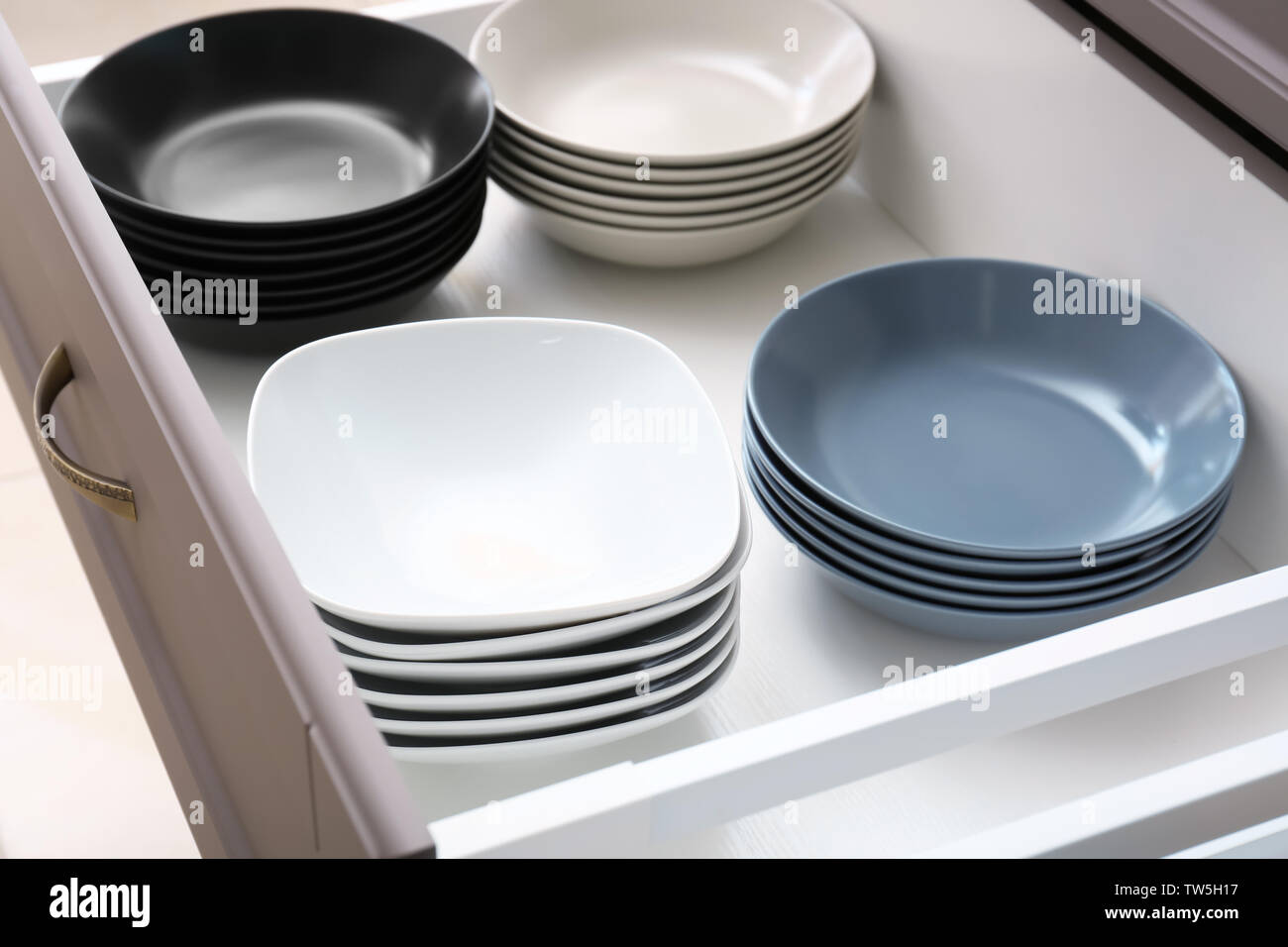 Plates in kitchen drawer Stock Photo Alamy