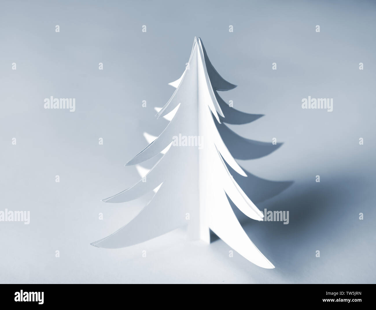 Christmas tree made of paper on light background Stock Photo - Alamy