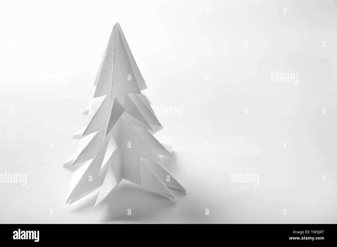 Christmas tree made of paper on white background Stock Photo - Alamy