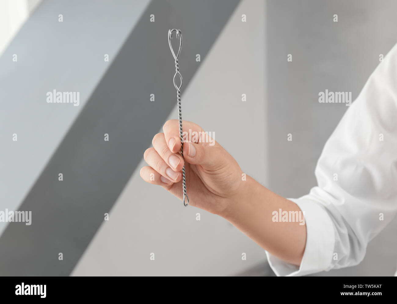 Hand of doctor with logopedic probe for speech correction in clinic Stock Photo