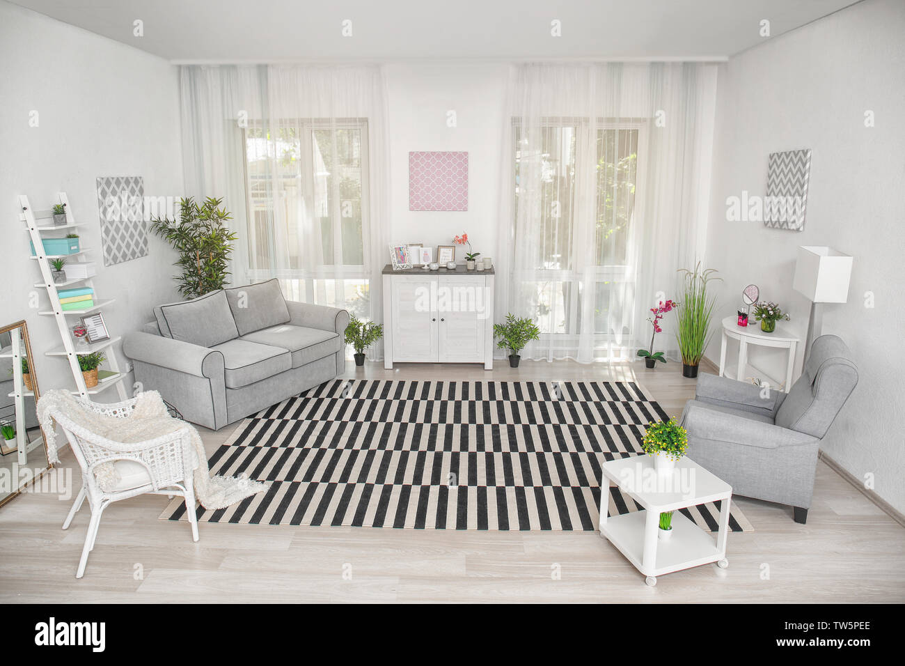 Modern living room design with big striped carpet Stock Photo - Alamy