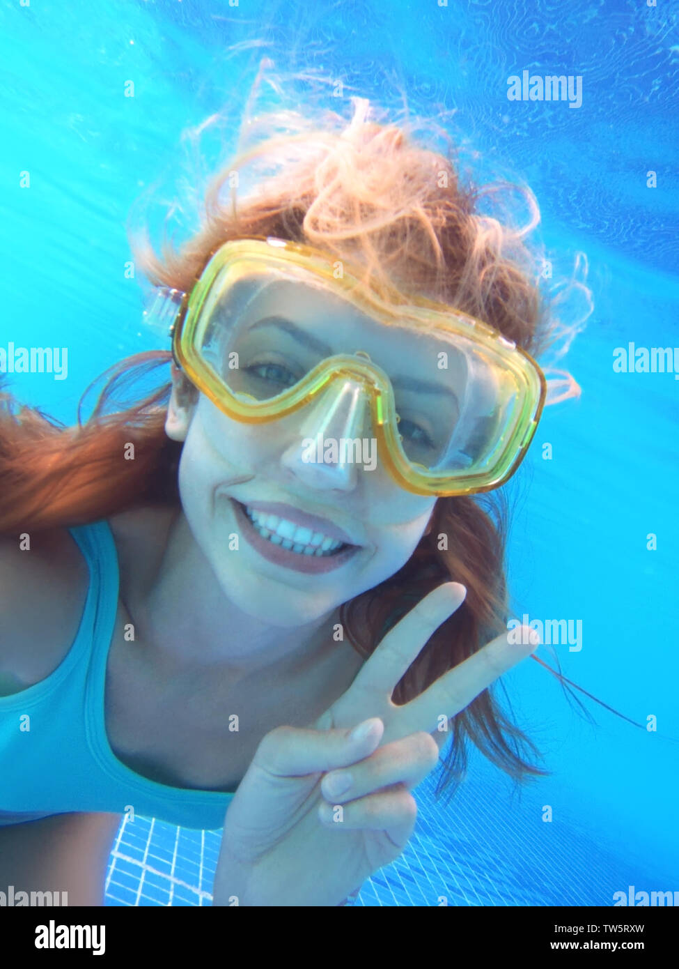 Beautiful young woman swimming under water in pool Stock Photo - Alamy