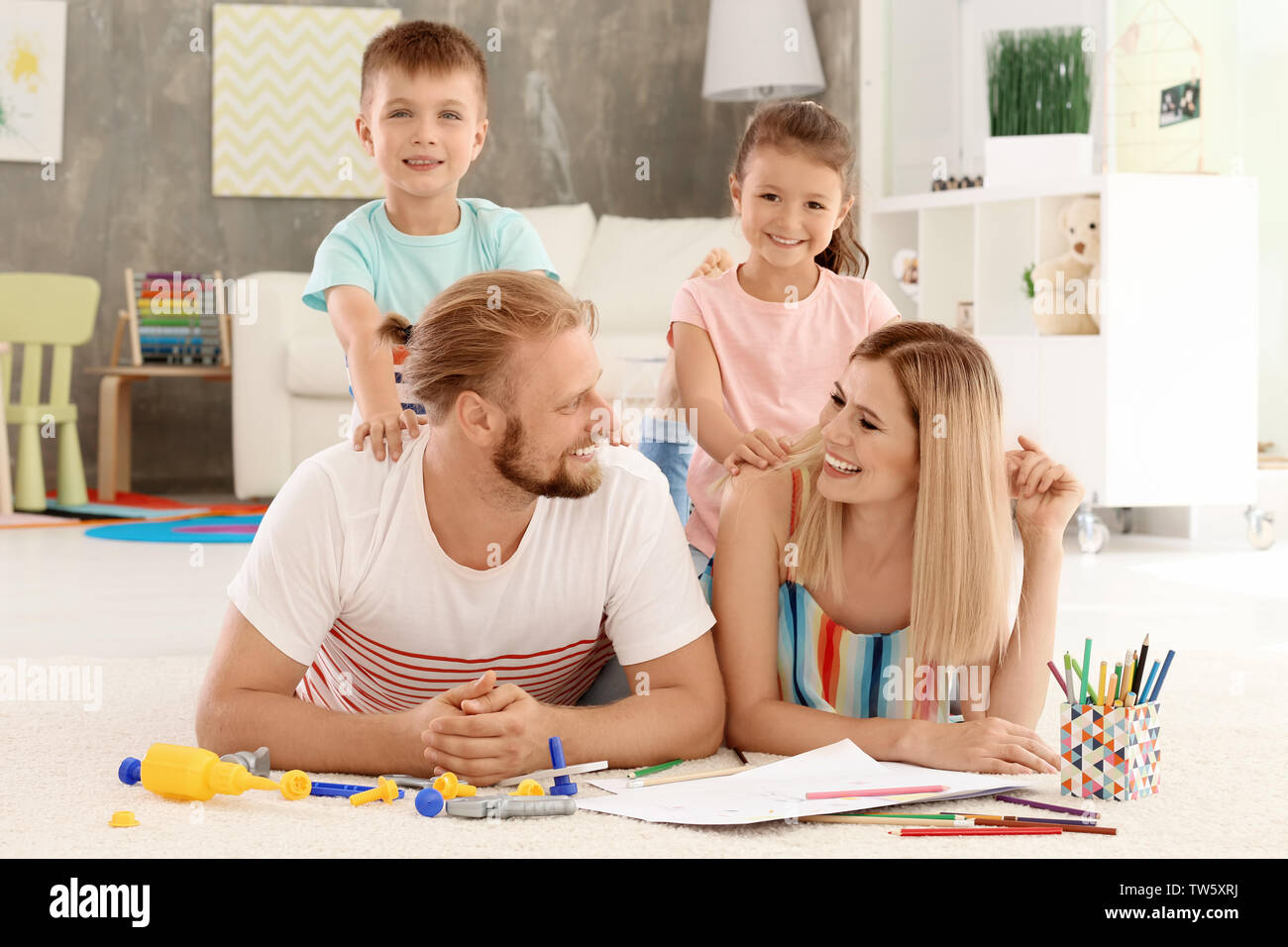 Parents spending time with children at home Stock Photo